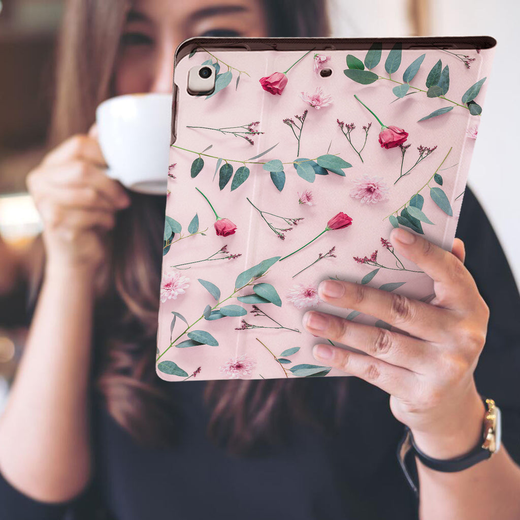 a girl is holding and viewing personalized iPad folio case with Flat Flower 2 design
