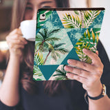 a girl is holding and viewing personalized iPad folio case with Tropical Leaves design