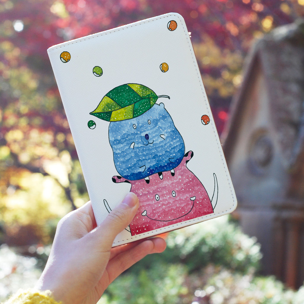 a girl holding personalized RFID blocking passport travel wallet with Cute Monster Enjoyillustration design