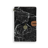 the front top view of midori style traveler's notebook with moody marble design