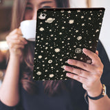 a girl is holding and viewing personalized iPad folio case with Space design 