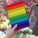 a girl holding personalized RFID blocking passport travel wallet with Rainbow design