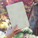 a girl holding personalized RFID blocking passport travel wallet with Romantic Leaves design