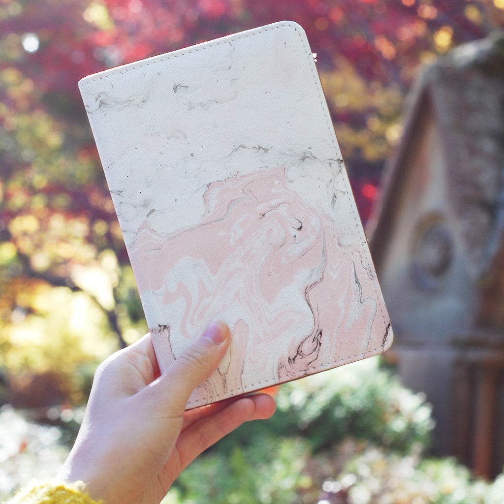 a girl holding personalized RFID blocking passport travel wallet with Pink Marble design